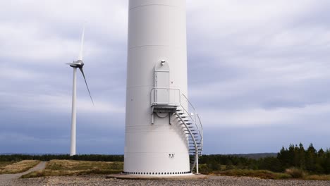 Shot-of-the-base-of-a-wind-turbine-on-a-wind-farm