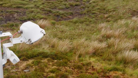 Shot-of-a-spotlight-attached-to-a-wind-turbine-on-the-moor-and-peatland