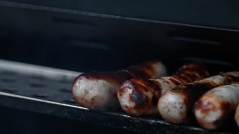 Sausages-Being-Placed-on-Grill-Grate-After-Smokey-BBQ-Cooking