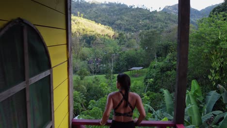 POV-follows-Latin-woman-walking-on-hotel-deck-to-view-jungle-overlook