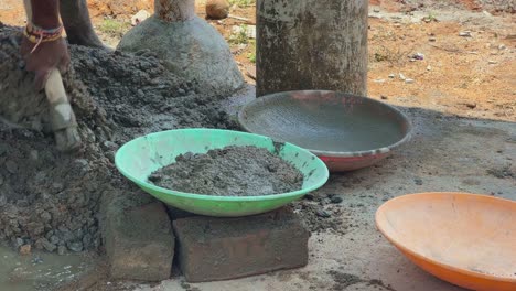 Indian-labour-mixing-cement-and-water-manually-on-floor-using-a-shovel