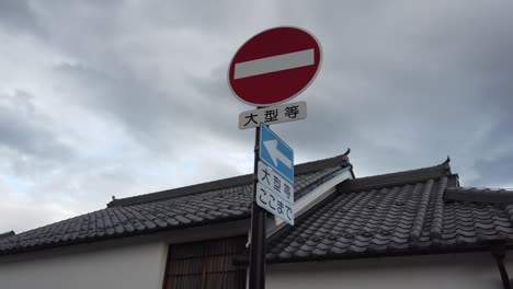 Wrong-Way-Traffic-Sign-In-Japanese-Kanji,-Japan-Warning-Red-Symbol-Hiragana-and-Katakana-Alphabet