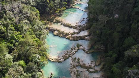 Tourists-swim-in-river-gour-pools-of-Semuc-Champey-valley,-Guatemala
