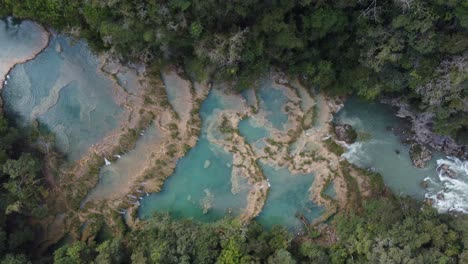Straight-down-aerial-of-Semuc-Champey-river-dam-waterfalls,-Guatemala