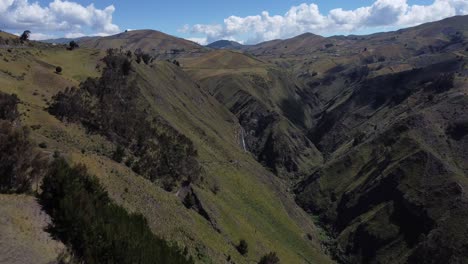 Incredible-4K-drone-flight-through-mountains-to-the-stunning-Candela-Fasso-waterfall-in-Jatun-Era,-Cotopaxi,-Ecuador
