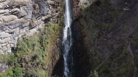 Experience-a-vertical-drone-ascent-from-bottom-to-top-of-Candela-Fasso-waterfall-in-Cotopaxi,-Jatun-Era