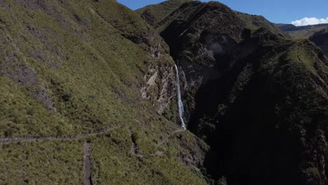 Immerse-in-a-cinematic-journey-as-the-drone-gracefully-approaches-Candela-Fasso-waterfalls-through-breathtaking-mountain