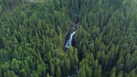Aerial-drone-view-Gollinger-waterfall,-Austria,-forest-landscape,-circle-pan
