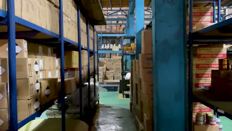 Camera-moves-forward-between-Corridor-in-warehouse-with-packages-in-logistic-room