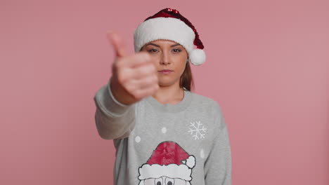Upset-woman-in-christmas-sweater-showing-thumbs-down-sign-gesture,-disapproval,-dissatisfied-dislike
