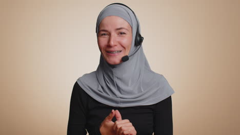 Muslim-woman-wearing-headset,-freelance-worker,-call-center-or-support-service-operator-helpline