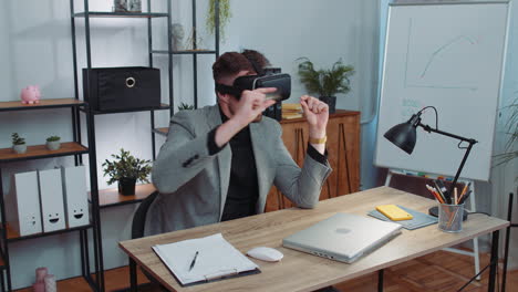 Businessman-working-using-virtual-reality-futuristic-technology-VR-app-headset-helmet-at-home-office