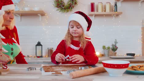 Ältere-Alte-Großeltern-Mit-Enkelkind-Bereiten-Kekse-In-Der-Weihnachtsküche-Zu-Hause-Vor