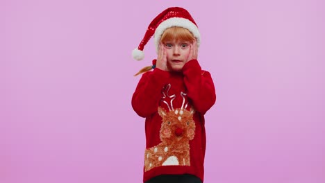 Child-girl-kid-in-Christmas-sweater-raising-hands-in-surprise-shocked-by-sudden-victory,-wow-emotion