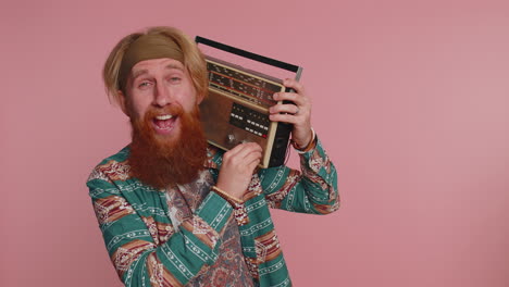 Hippie-redhead-man-using-retro-vintage-tape-record-player-to-listen-music,-disco-dancing-having-fun