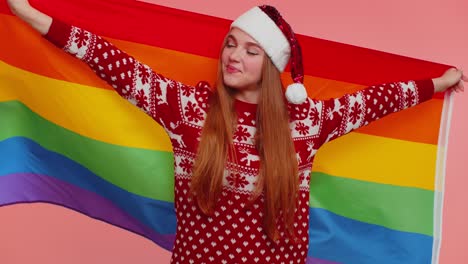 Girl-in-Christmas-sweater-posing-with-rainbow-flag-celebrate-parade-tolerance-same-sex-marriages