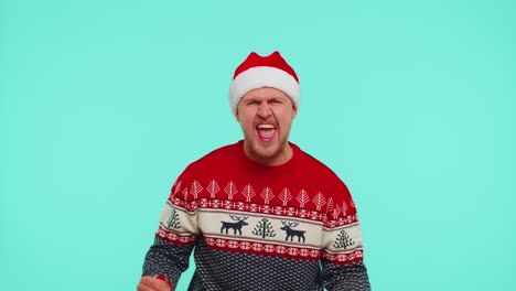 Man-in-Christmas-sweater-listening-music-via-earphones,-dancing-disco-fooling-around-having-fun