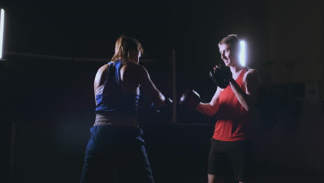 Junge-Erwachsene-Frau-Macht-Kickboxtraining-Mit-Ihrem-Trainer.