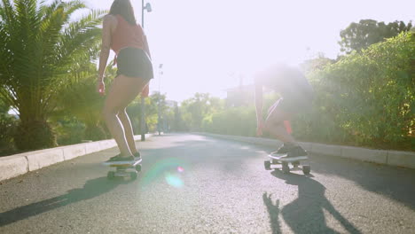 Amid-the-island's-tranquility,-they-skateboard-along-park-paths-in-slow-motion,-the-sunset's-glow-adds-to-their-joy-and-healthy-lifestyle