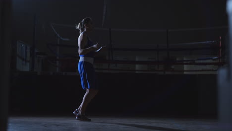 Beautiful-female-boxer-jumping-rope-during-active-Boxing-training