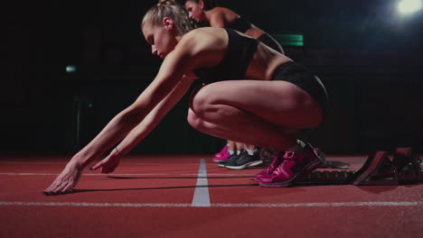 Female-athletes-warming-up-at-running-track-before-a-race.-In-slow-motion