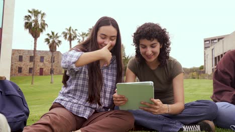 Cheerful-friends-using-tablet-computer