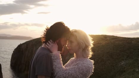 Couple-hugging-against-sundown-sky