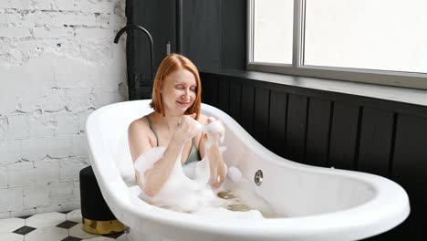 Cheerful-woman-playing-with-foam-in-bathtub