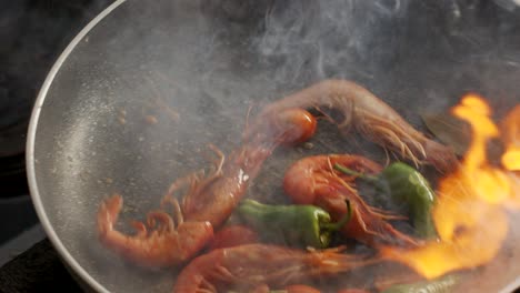 Cooking-shrimps-in-frying-pan-with-flame