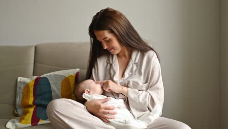 Young-mom-caressing-sleeping-infant