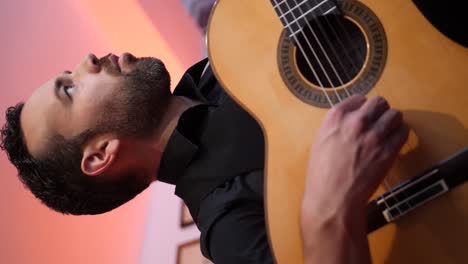 Bearded-man-playing-song-on-guitar