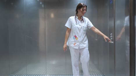Female-doctor-using-elevator-in-hospital