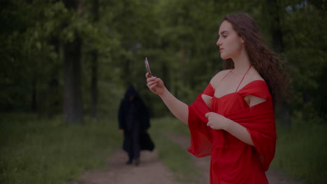 Woman-In-Red-Dress-And-Reaper-In-Forest