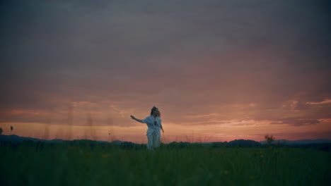 Woman-Running-On-A-Meadow-At-Dusk