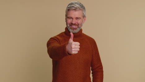 Middle-aged-man-raises-thumbs-up-agrees-or-gives-positive-reply-recommends-advertisement-likes-good