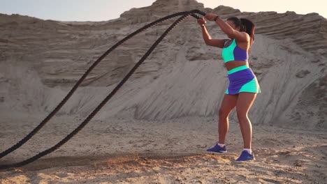 Athletic-woman-doing-crossfit-exercises-with-a-rope-outdoor.