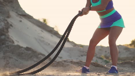 Female-athlete-training-outdoors-around-the-sand-hills-at-sunset.-Active-physical-activity-workout.-crossfit
