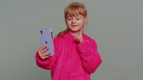 Child-girl-kid-blogger-taking-selfie-on-smartphone,-video-call-online,-recording-social-media-story