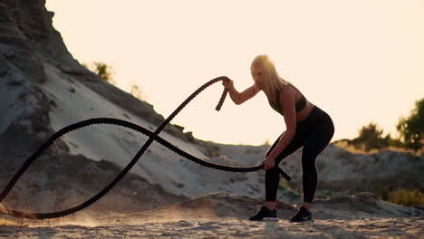 Athletic-woman-doing-crossfit-exercises-with-a-rope-outdoor
