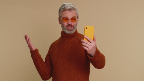 Middle-aged-man-traveler-blogger-taking-selfie-on-smartphone,-communicating-video-call-online-stream
