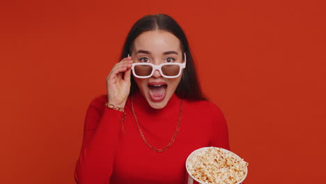 Excited-woman-in-3D-glasses-eating-popcorn-and-watching-interesting-tv-serial,-sport-game-film-movie