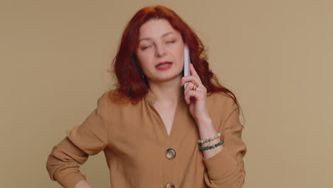 Redhead-woman-tired-sleepy-freelancer-talking-on-mobile-phone-with-friend-making-online-conversation