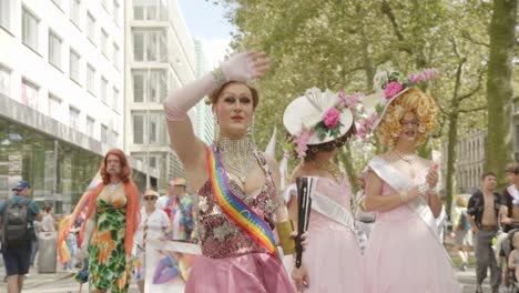 Three-dragqueens-dancing-and-wavig-during-the-Antwerp-Pride-Parade-2023-in-Belgium