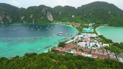 Thailand-Koh-Phi-Phi-islands-in-Krabi-province-aerial-panoramic-view-of-scenic-bay-with-paradise-tropical-beach-and-rock-mountain-limestone-formation-Asia-travel-holiday-destination-drone-footage
