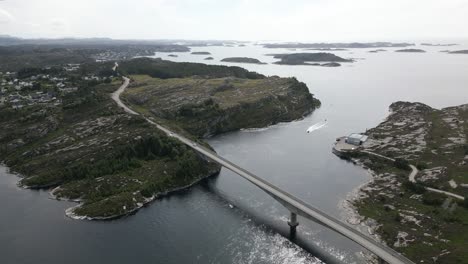 Aerial-footage-of-Cars-Driving-Driving-over-a-Bridge-in-Øygarden,-Norway-near-Bergen-with-Beautiful-Landscape