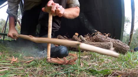 close-up-shot-of-a-australian-bushman-creating-primative-fire-with-a-bow-drill