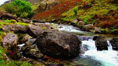 A-small-stream-flows-through-a-lovely-coloured-rocky-landscape-in-Snowdonia