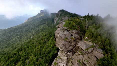 aerial-pullout-of-clouds-and-fog-atop-grandfather-mountain-from-linville-nc,-north-carolina