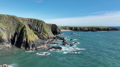 Coast-of-Ireland-dramatic-sea-cliffs-at-Dunabrattin-Head-on-The-Copper-Coast-Waterford-on-a-magic-summer-day