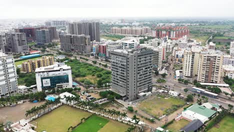 Aerial-view-of-Rajkot-city,-drone-camera-is-moving-around-and-high-rise-commercial-and-residential-buildings-are-visible-on-all-sides-in-the-city